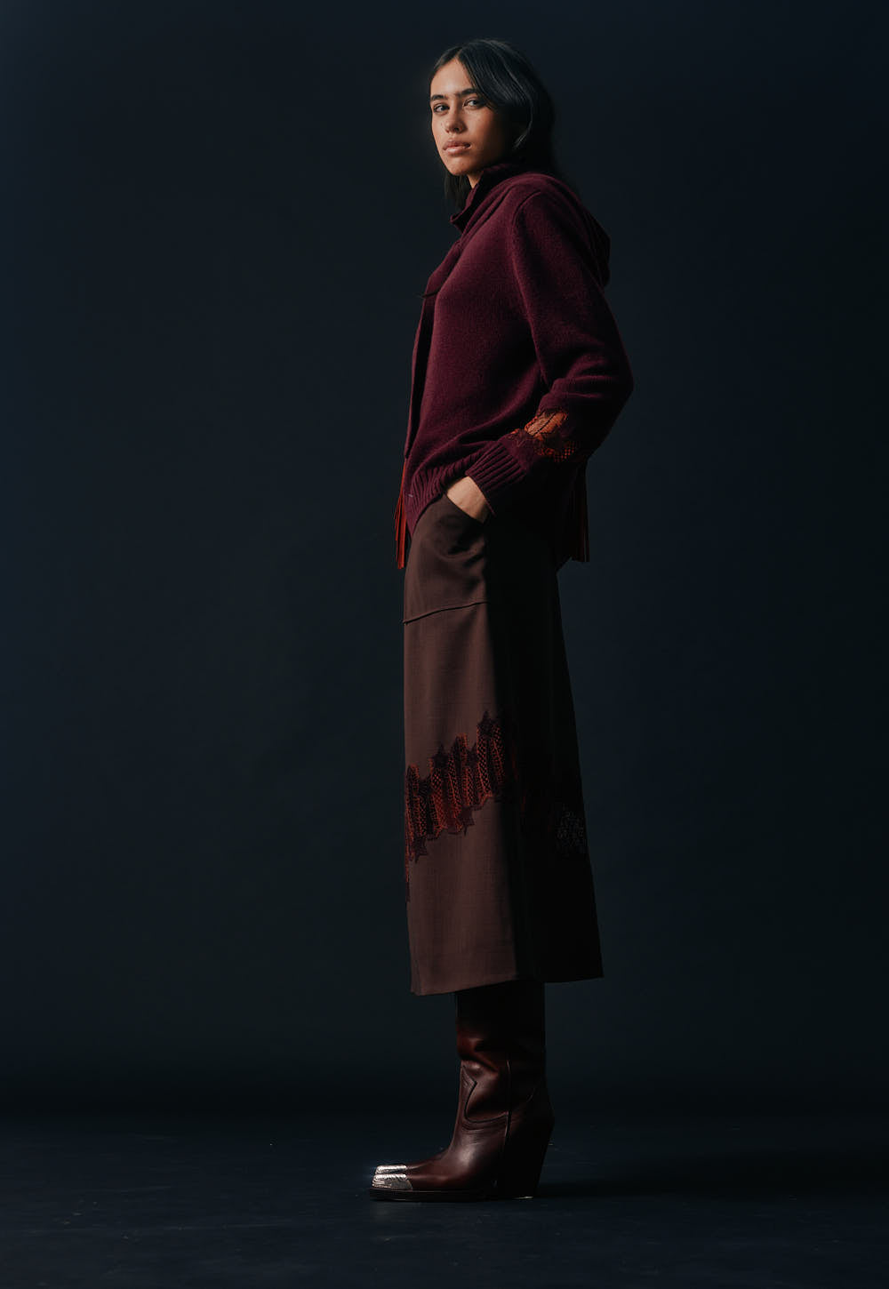 Model wearing the Antonia Zander Romina Skirt in bordeaux styled with a matching cashmere knit and leather boots.